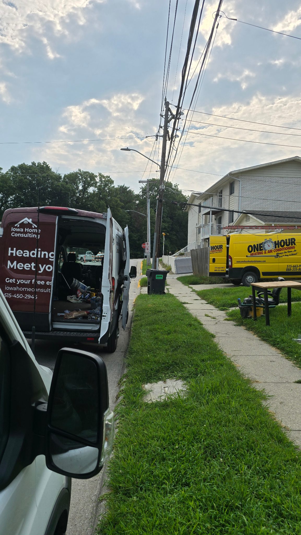 Iowa Home Consulting van parked on a street in Ames, Iowa, ready for a rental property turnover project.
