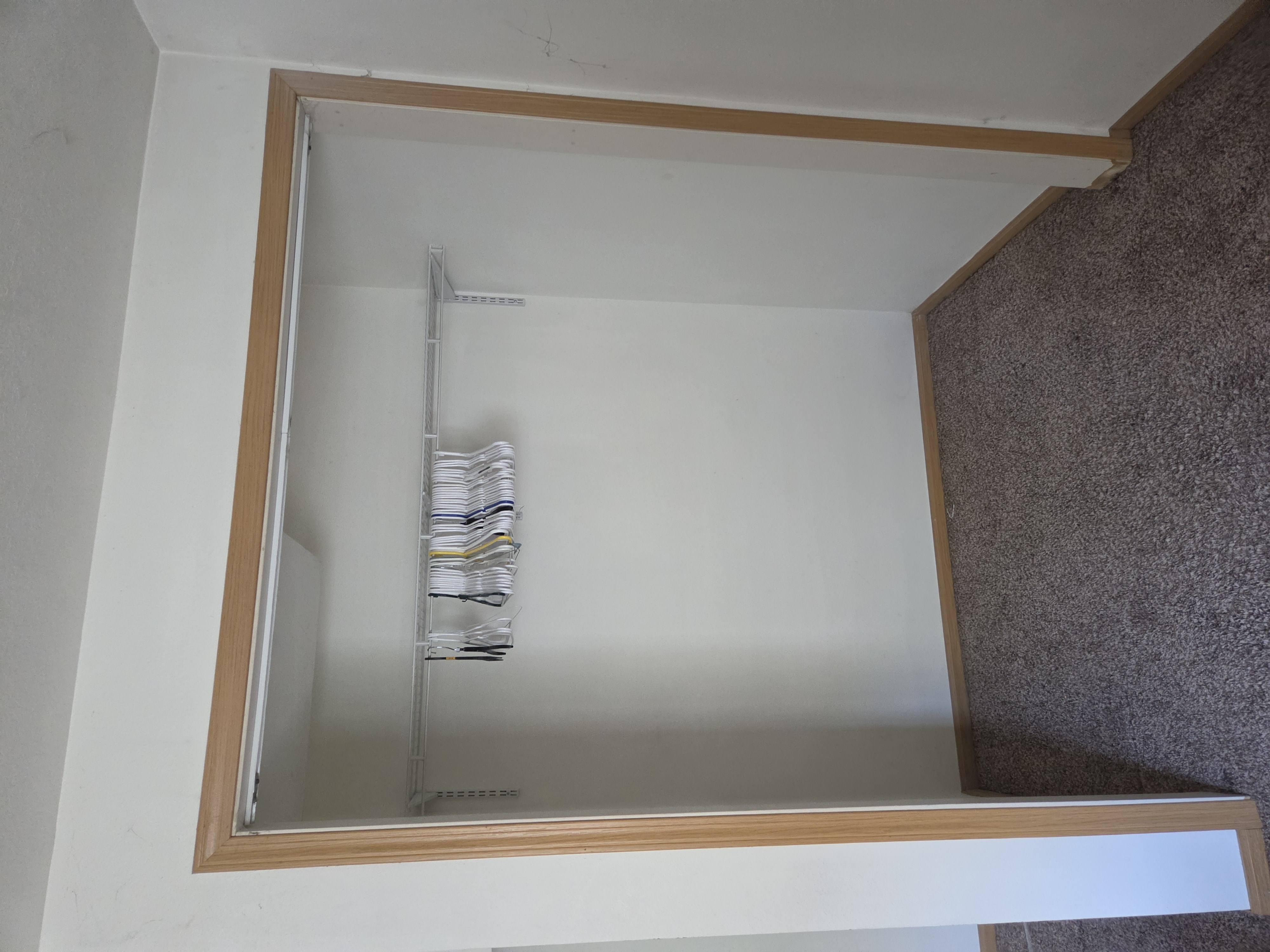 Empty closet with a wire shelving system, Ames rental property turnover project.