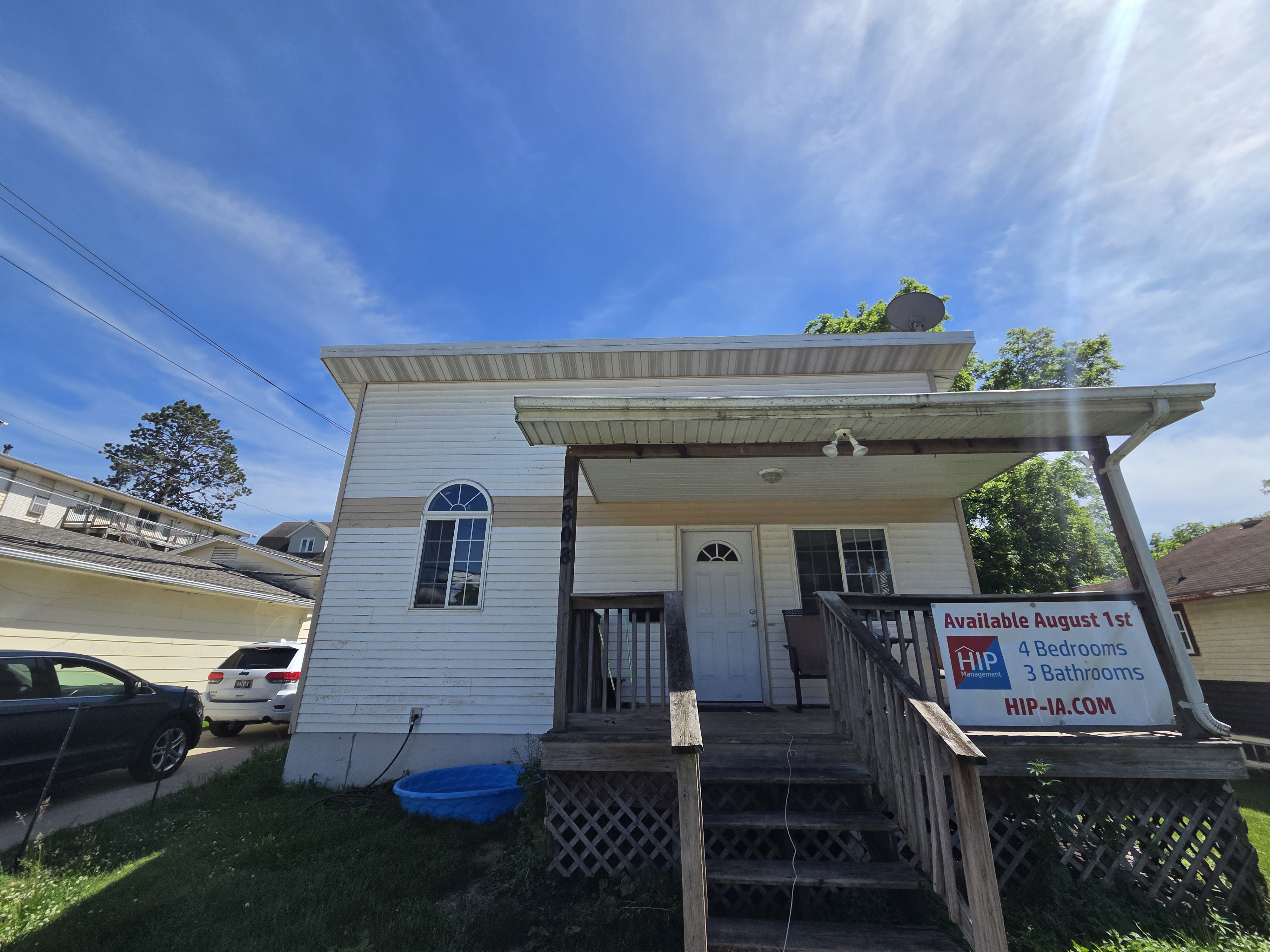 Front exterior of a rental house with a porch and steps, Ames rental property turnover project.