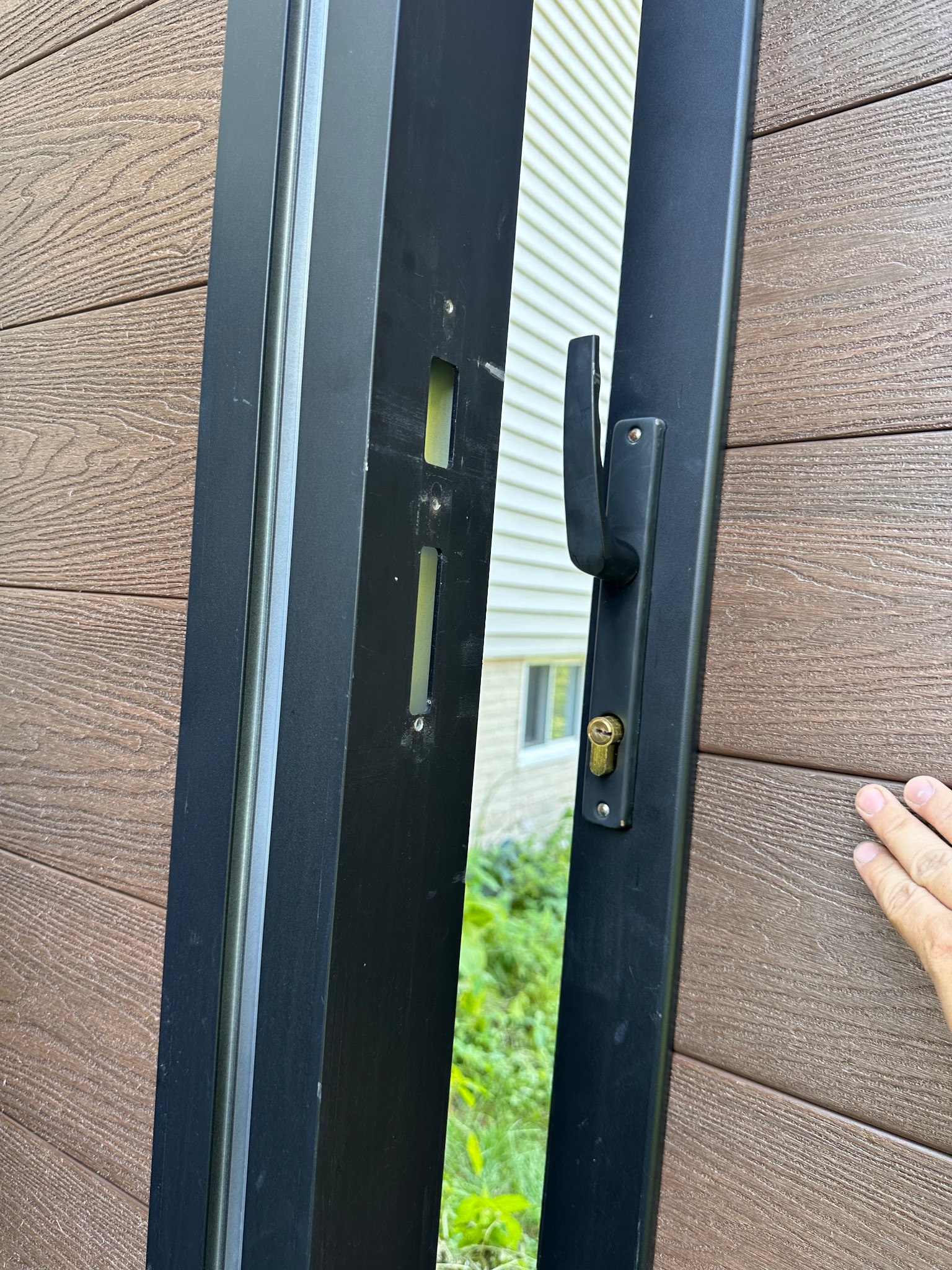 Newly installed brown composite fence and gate in Des Moines, Iowa