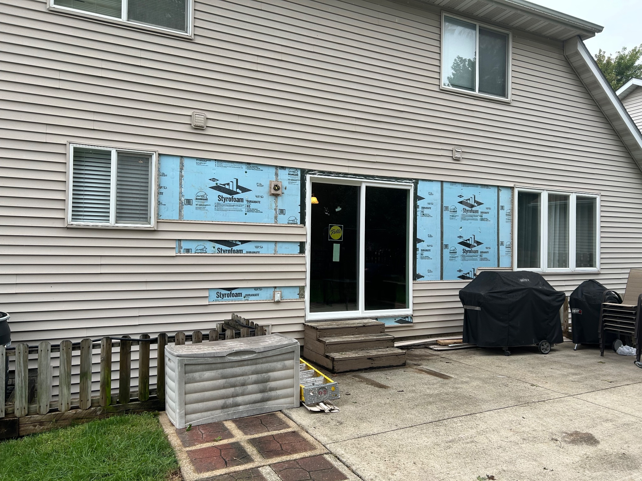 During installation of a patio door in Ames, showing insulation and the new door frame installed in the opening.