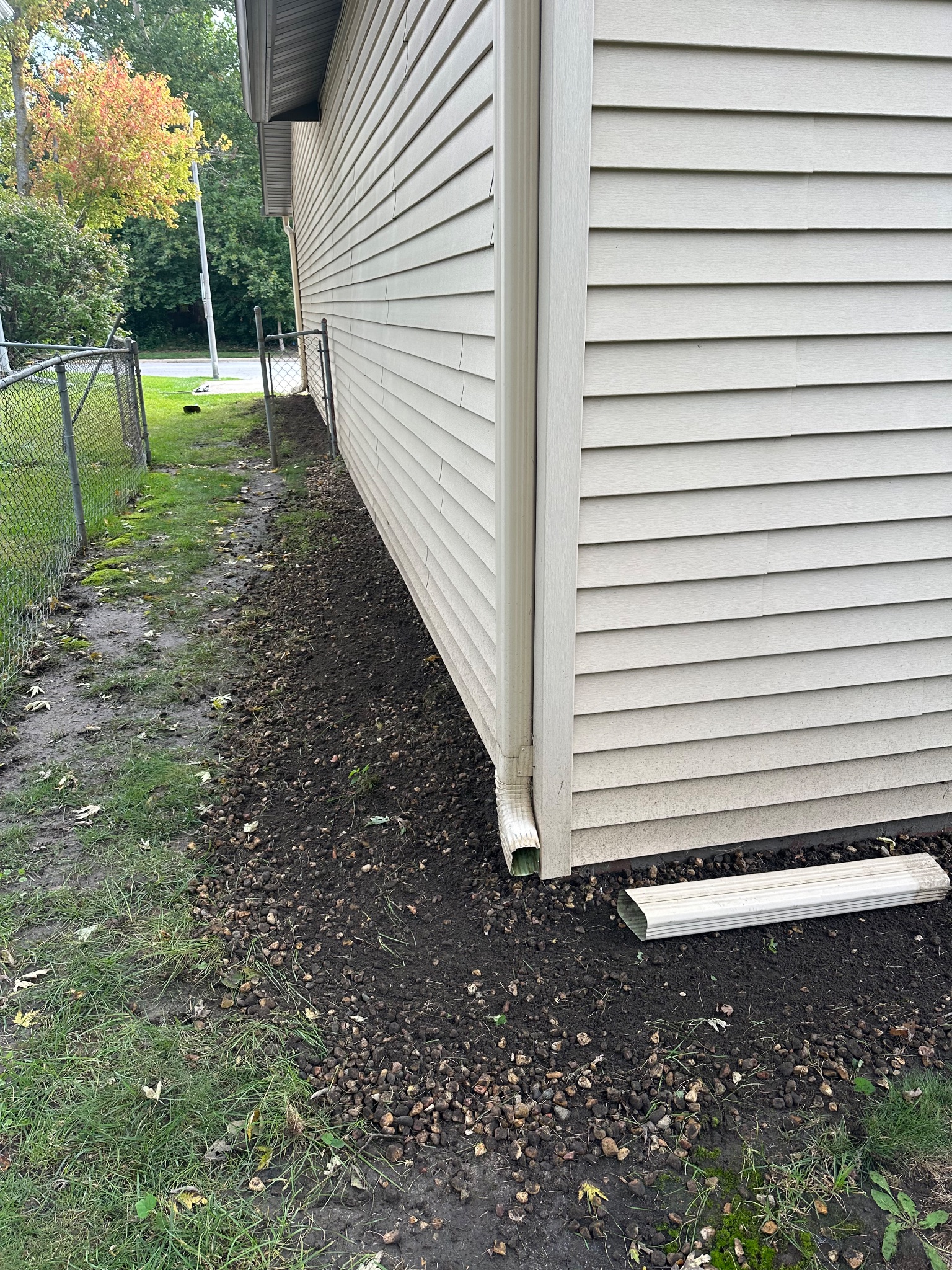 Iowa Home Consulting technician sealing chimney flashing on a roof in Ames.