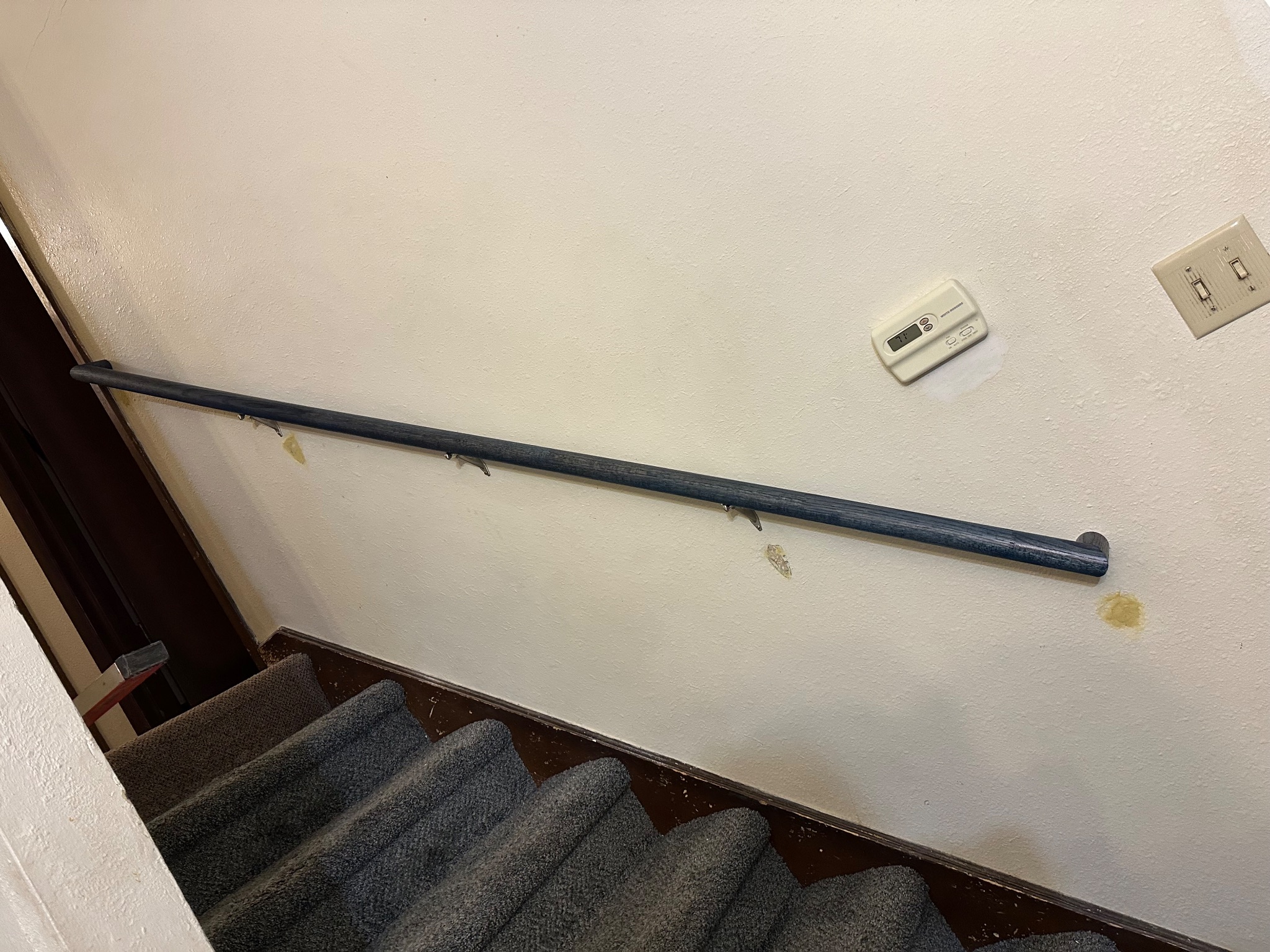 Previously installed handrail with exposed mounting points in Ames, IA