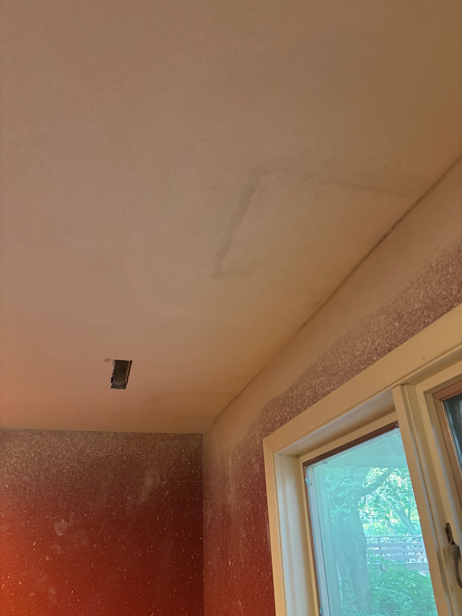Newly patched ceiling drywall in Ames after handyman repair.