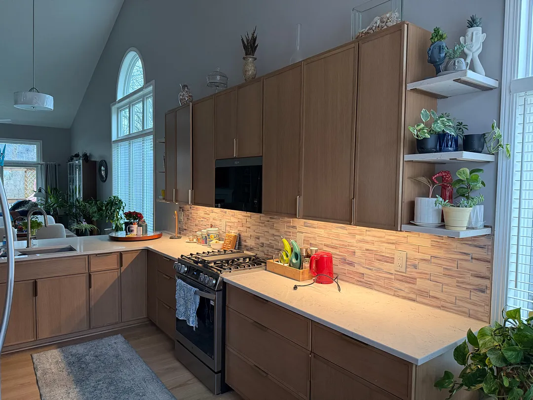 After photo of a modern kitchen remodel featuring a sleek backsplash and updated fixtures in Des Moines.