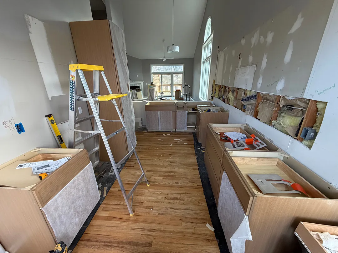 During renovation photo of a kitchen with partially installed new cabinetry in Des Moines.