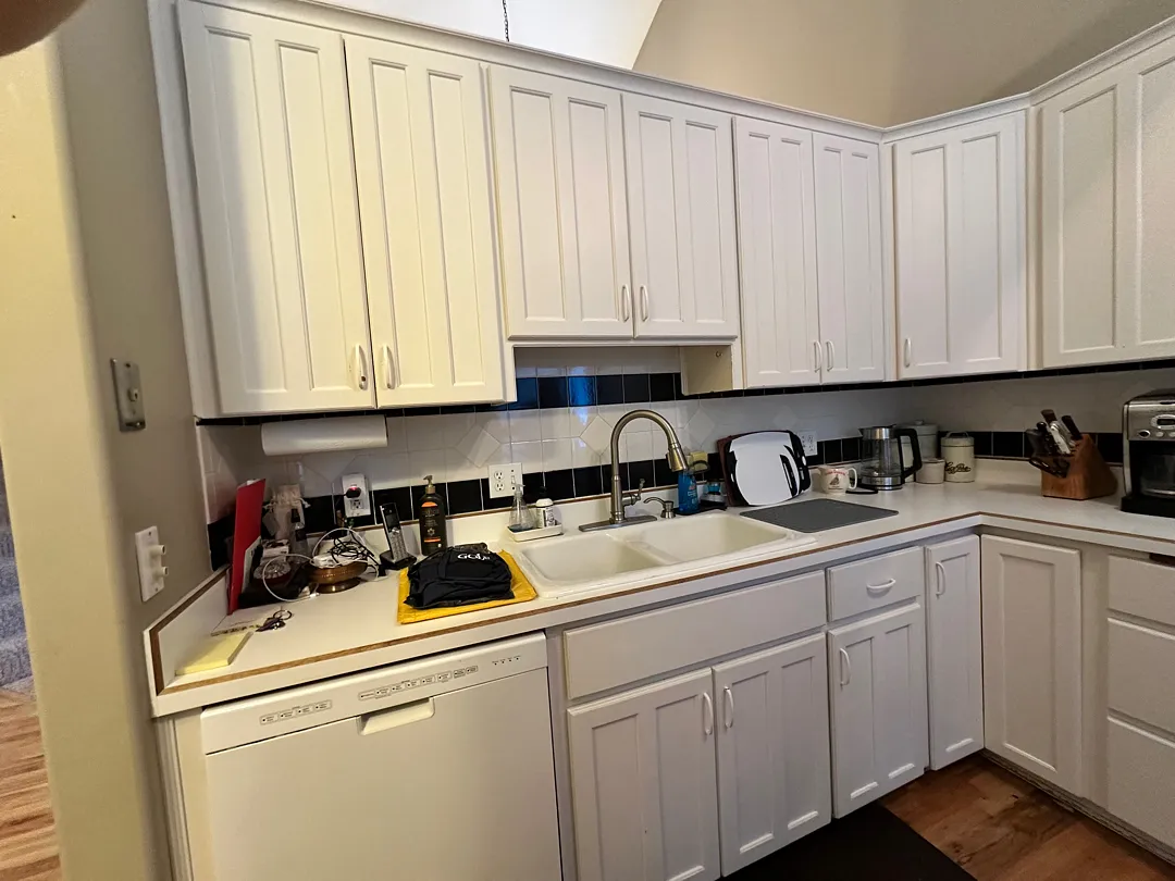 Before photo of an older kitchen with existing cabinetry and appliances in Des Moines.
