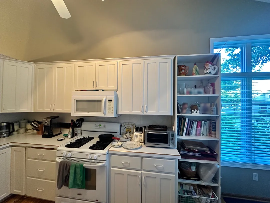 Before photo showing the original kitchen entryway and flooring in Des Moines.